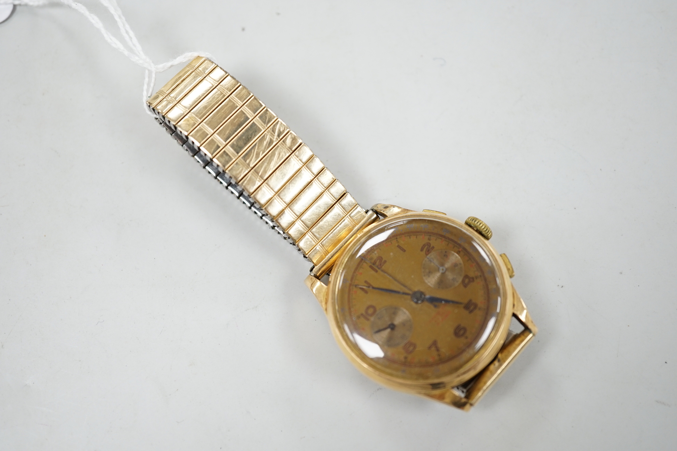 A 1950's? Swiss 18k chronograph manual wind wrist watch, on later associated flexible bracelet.